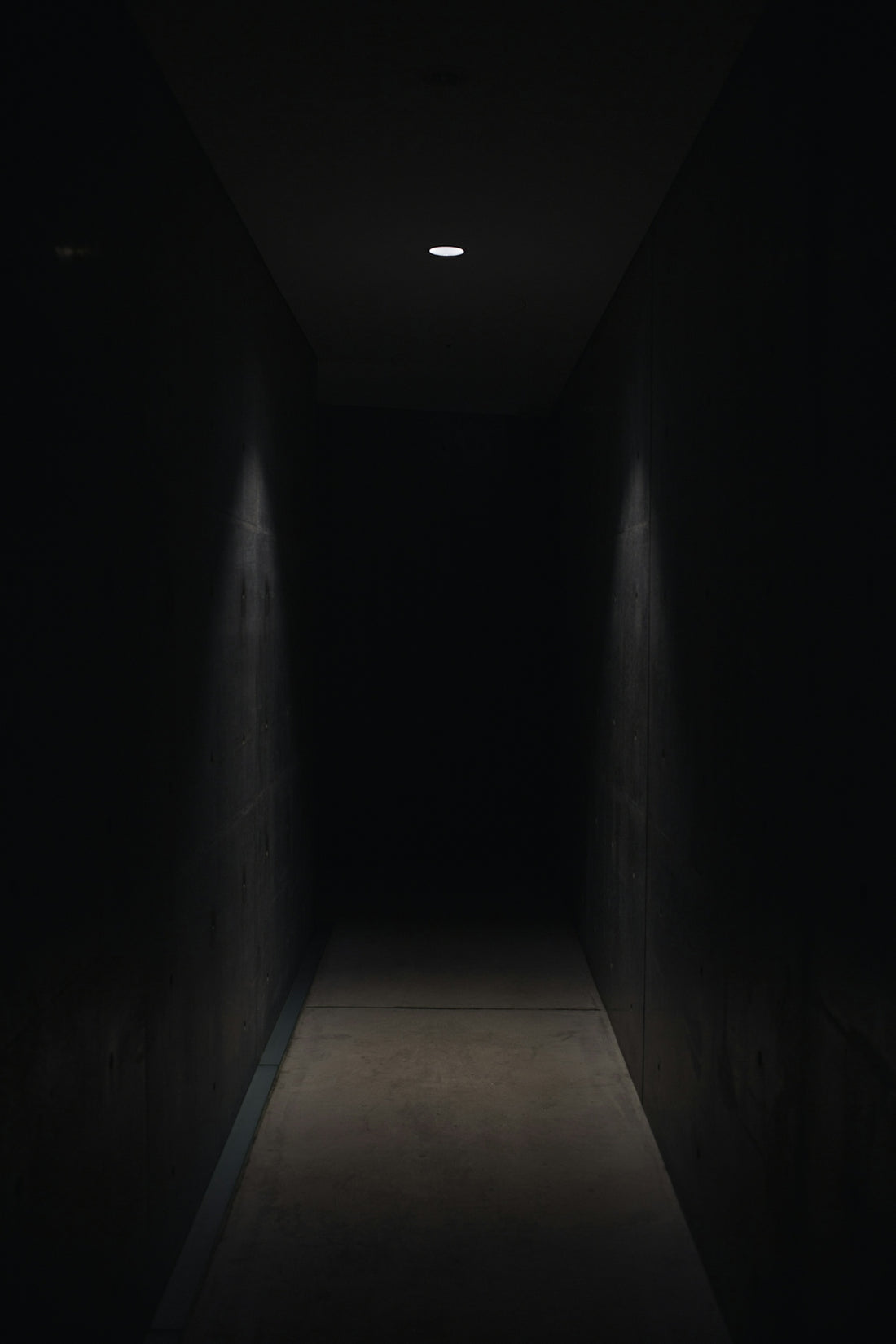 dark pathway lit with small light fixture